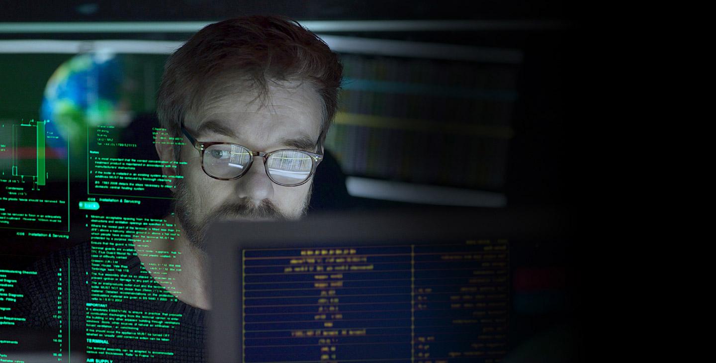 Man wearing glasses looking at projected computer data